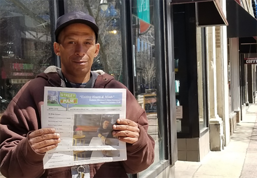 Street Pulse vendor, Dominic sells papers at his usual spot on State Street