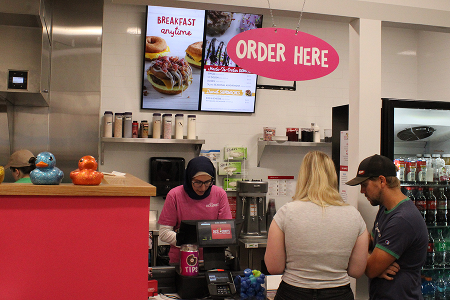 Customers place their order at Duck Donuts during its grand opening on Aug. 17.