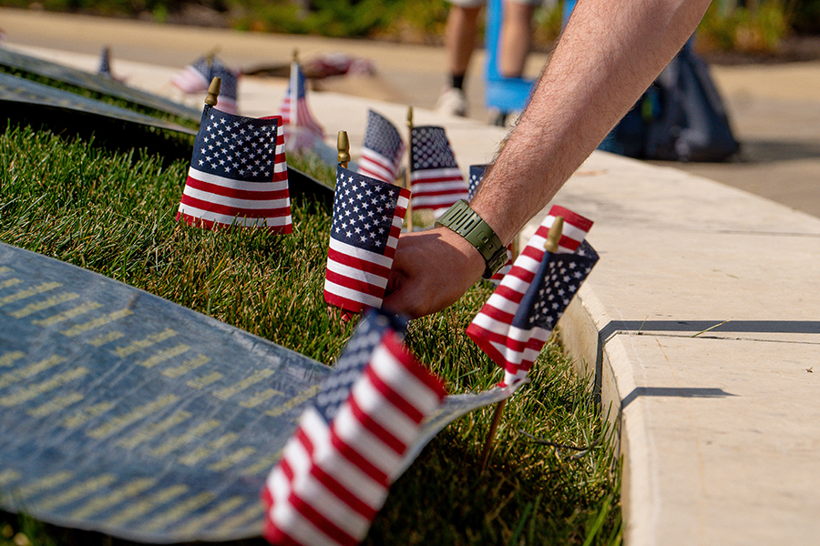 Students and staff plant small flags on Lussier Student Plaza in memory of the victims of the victims of the 9/11 attack 23 years ago.