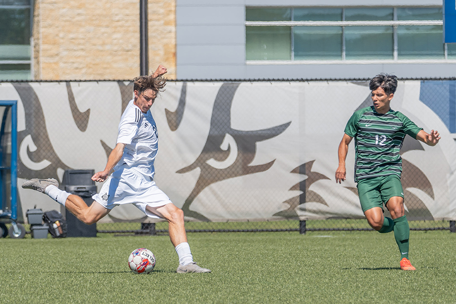 Madison College's Cole Rogers(20) steps in to strike the ball and get it to the opponent's side of the field.