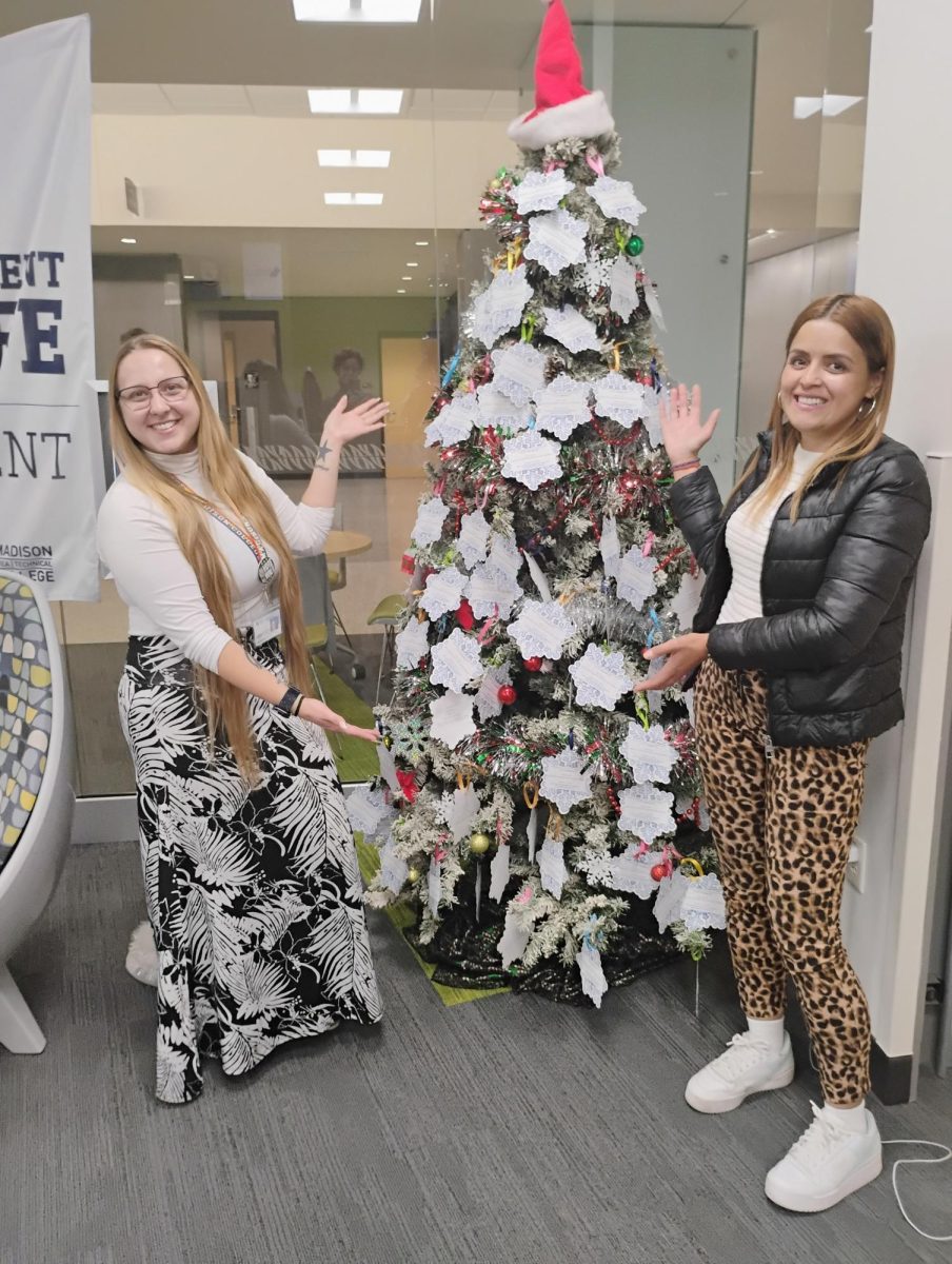 Scarlet Martino (left) and Andrea Renteria (right) showing off the Santa's Wishlist tree in Traux Student Life