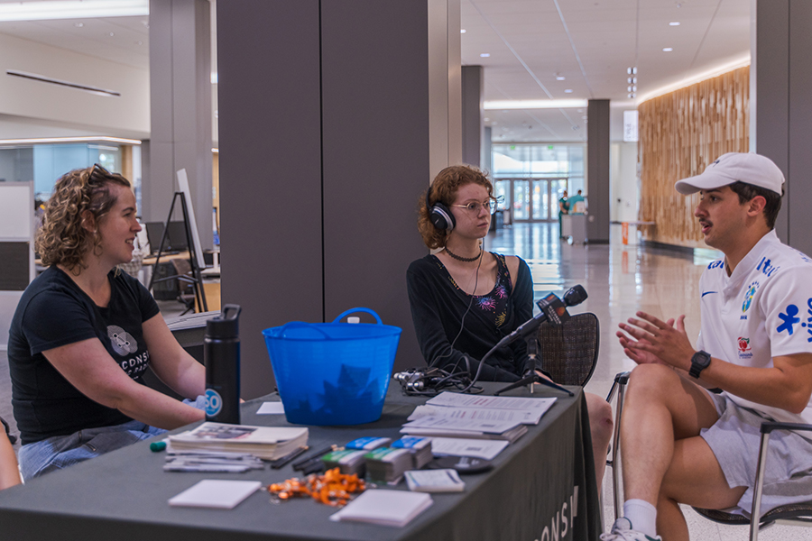 A student visits with Bridgit Bowden, left, Special Projects Reporter for Wisconsin Public Radio, and Sara Bernabe, center, managing editor of The Clarion.