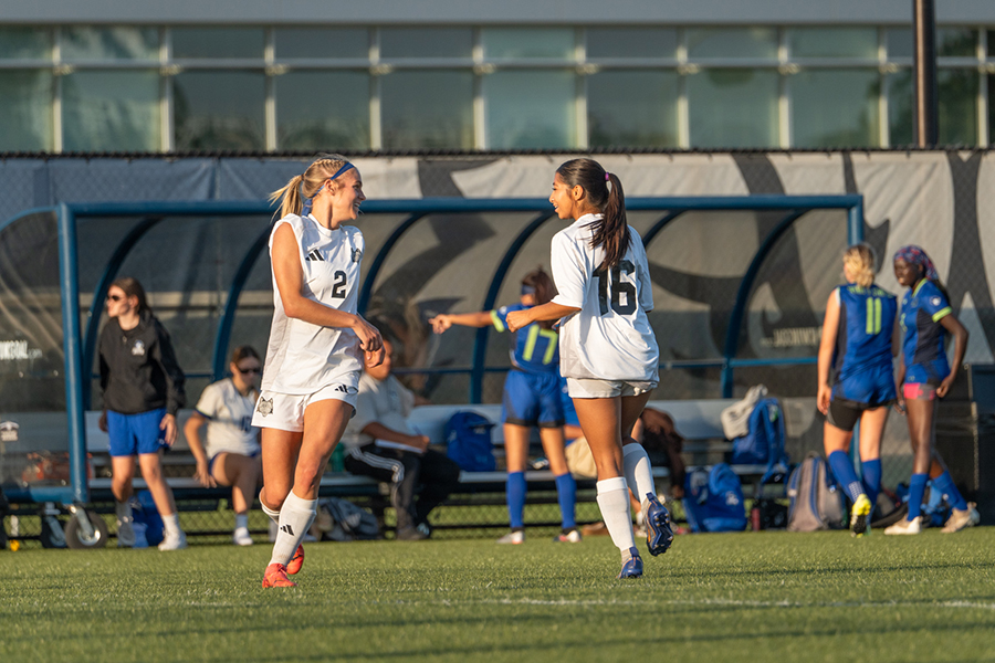 Ava Schmidt, left, and Atrizy Ocampo skip in a circle, waiting for the game to resume on Wednesday, Oct. 2, 2024.