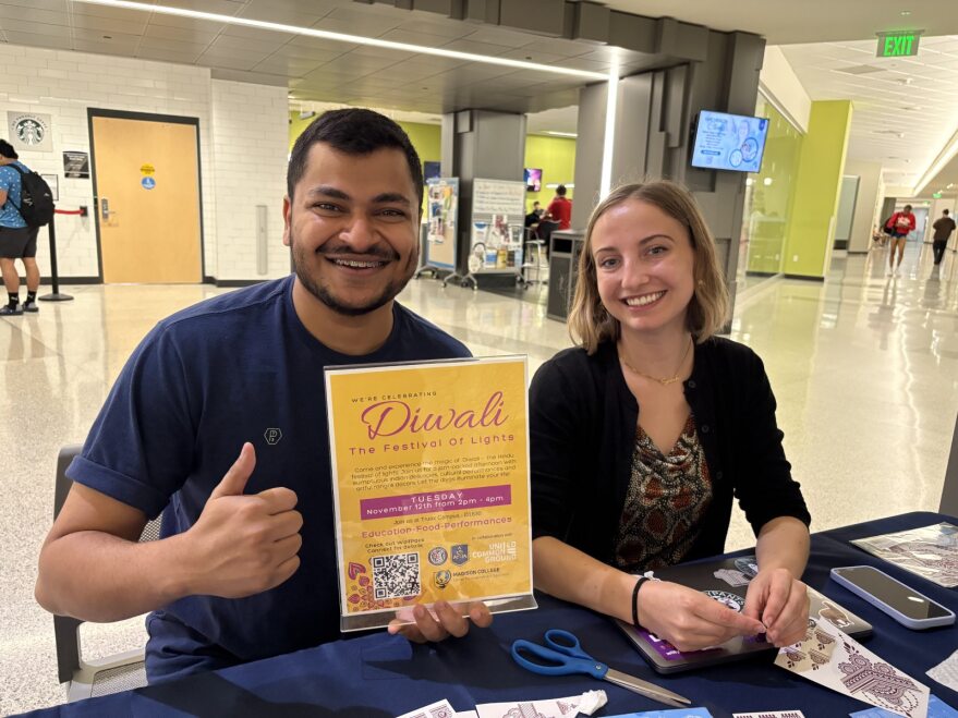 Writer Abi (left) and Diwali planning committee partner, Sarah (right) host the festival's tabling event at Madison College