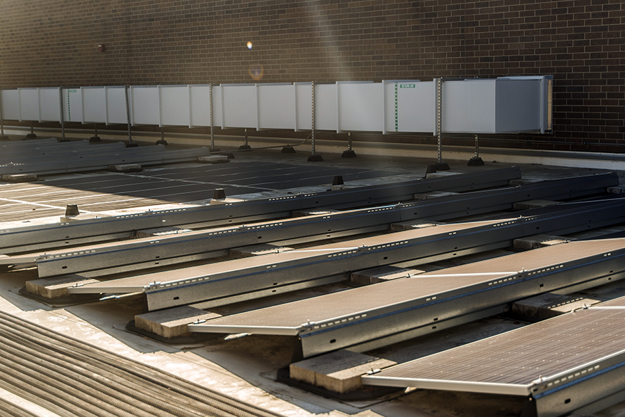 Solar panels are fixed on top of the main Truax Campus building. Soon solar panels will be added to the Protective Services Building.