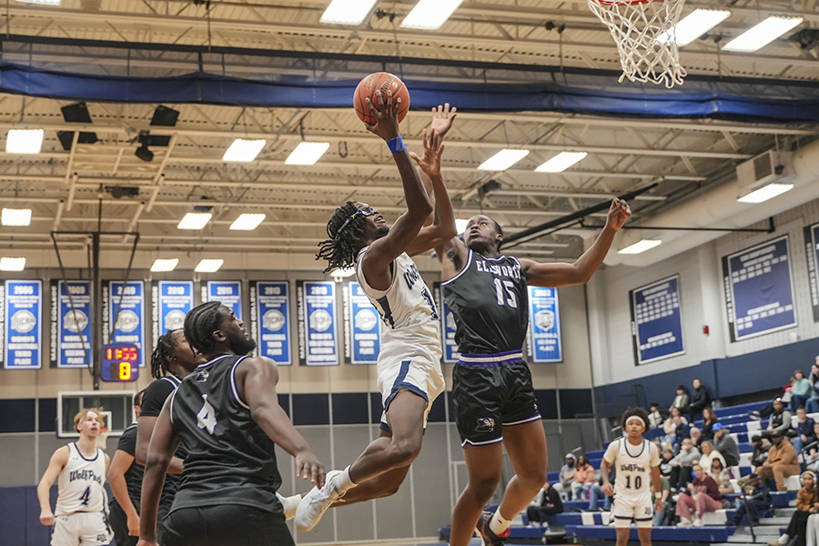 Madison College’s Amir Ford, center, soars to the basket in a 79-72 loss against Ellsworth Community College on Jan. 4. Photo by Hunter Radke.