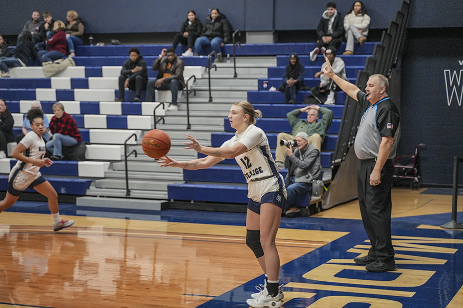 Madison College’s Aubrie Maass (12) inbounds the ball against Harry S. Truman College on Jan. 4. The WolfPack posted a 96-54 victory.