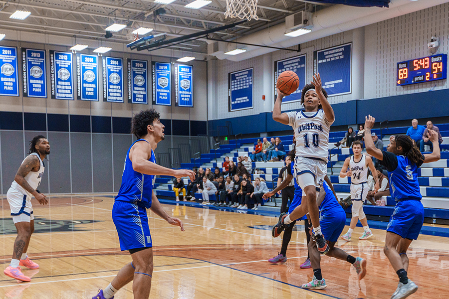 Madison College's George Whaley IV jumps to shoot the ball during a game at the Redsten Gymnasium.