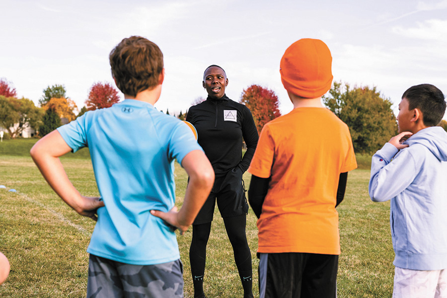 Ziggy Odogun speaks to a group of young soccer players at a camp she organized and ran.